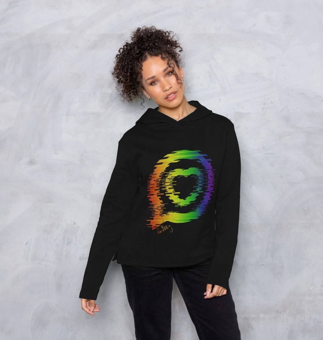 Woman wears relaxed fit black hooded top with the roo betty logo in "torn" rainbow design