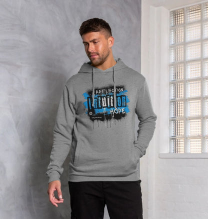 male model wears Unisex grey hooded sweatshirt  with the words reflection intuition hope the 3rd eye chakra design from the words to empower collection 