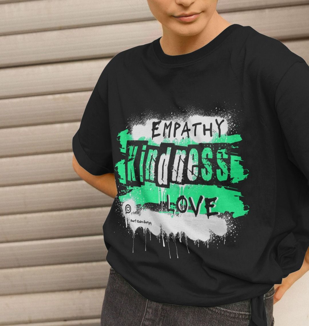 female model wears the relaxed fit t-shirt in black with the green heart chakra energy design to the front 