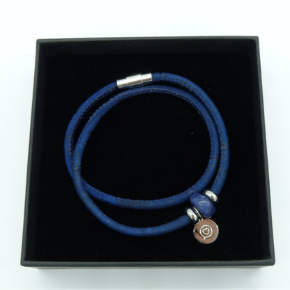 Blue cork bracelet with stainless steel magnetic clasp . Gemstone Sodalite bead with stainless steel tag with the logo of Roo Betty of a heart in a speech bubble . Presented in a black gift box