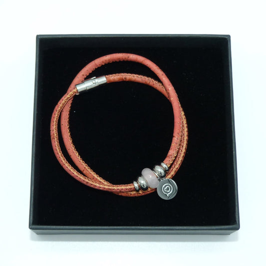 Peach Pink cork bracelet with stainless steel magnetic clasp . Gemstone Rose Quartz bead with stainless steel tag with the logo of Roo Betty of a heart in a speech bubble . Presented in a black gift box