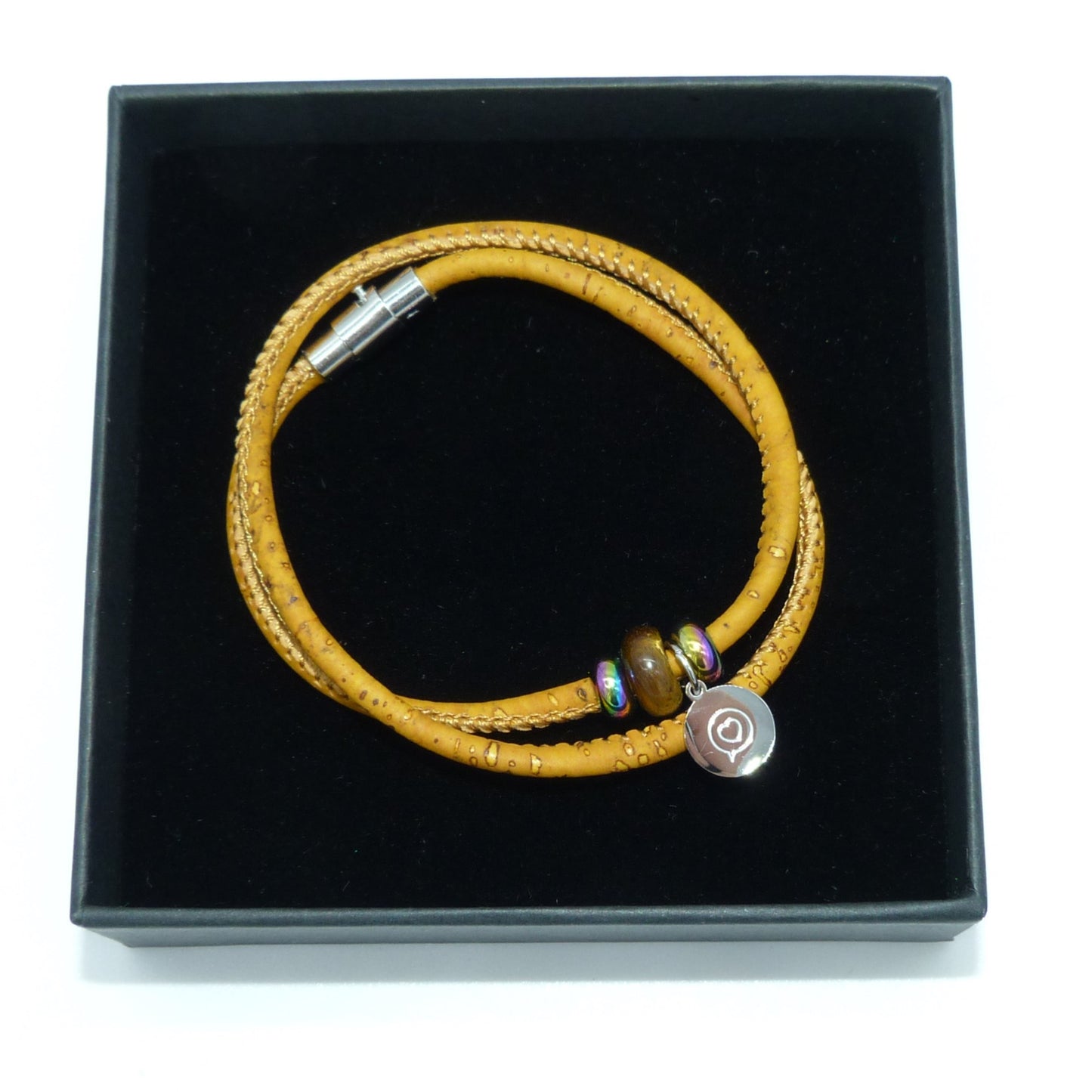 Yellow cork bracelet with stainless steel magnetic clasp . Gemstone Tiger’s eye  bead with stainless steel tag with the logo of Roo Betty of  a heart in a speech bubble .  Presented in a black gift box