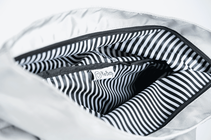 The Roo betty Nyx backpack has signature black and white stripe lining that makes it shower proof