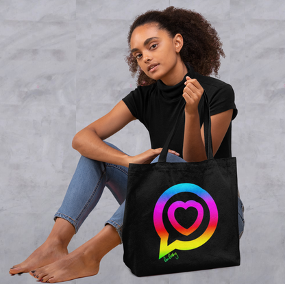 Model holds large black organic cotton tote bag with the roo betty logo on in in bright vinyl colours