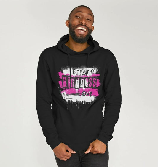 male model wears a black hooded sweatshirt with the words empathy kindness love from the words to empower collection in bright pink 